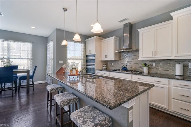604 Baker Loop, Chesapeake, VA 23320 - kitchen featuring wall chimney range hood, healthy amount of natural light, tasteful backsplash, stainless steel appliances, and recessed lighting