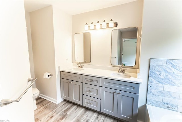 2408 Raynor Ct, Virginia Beach, VA 23456 - bathroom featuring toilet, double vanity, wood finished floors, and a bathtub