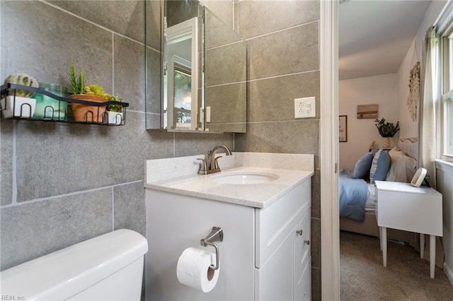 1032 Kincaid Ter, Chesapeake, VA 23320 - half bath featuring vanity, tile walls, healthy amount of natural light, and toilet