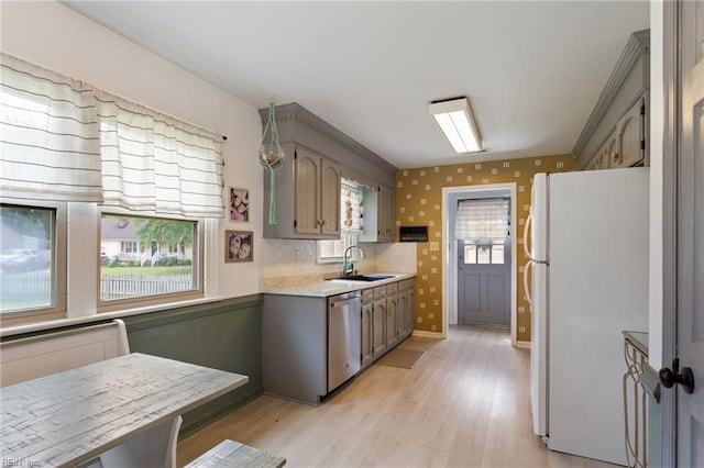 1032 Kincaid Ter, Chesapeake, VA 23320 - kitchen featuring freestanding refrigerator, stainless steel dishwasher, a sink, light countertops, and light wood-style floors