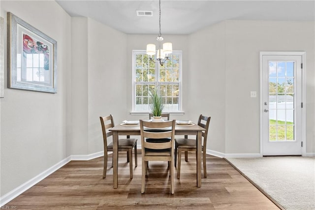 209 Apple Ct, Elizabeth City, NC 27909 - dining space with a chandelier, baseboards, and wood finished floors