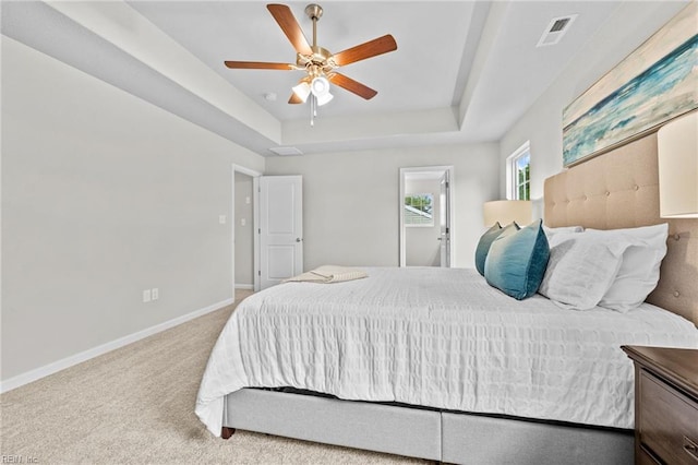 209 Apple Ct, Elizabeth City, NC 27909 - carpeted bedroom featuring a raised ceiling, baseboards, and ceiling fan