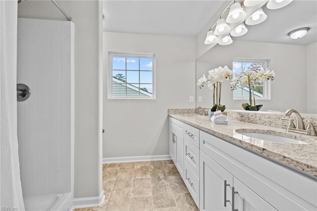 209 Apple Ct, Elizabeth City, NC 27909 - full bath with double vanity, a tile shower, and baseboards