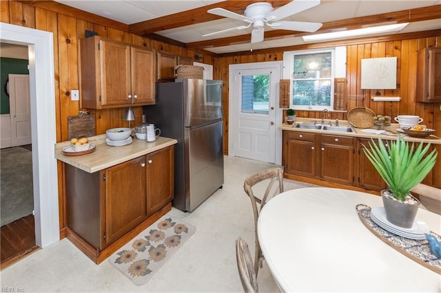 1330 Laurel Cres, Norfolk, VA 23505 - kitchen featuring freestanding refrigerator, a sink, wood walls, brown cabinetry, and light floors