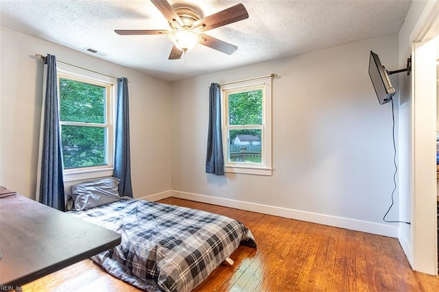 795 Old Oyster Point Rd, Newport News, VA 23602 - bedroom featuring a textured ceiling, wood finished floors, and a ceiling fan