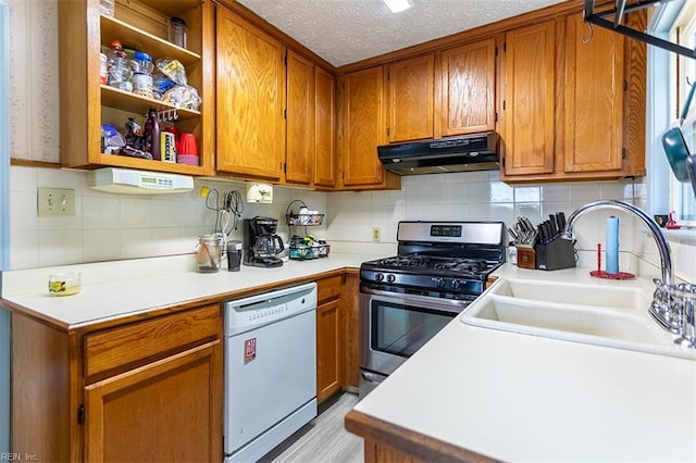 795 Old Oyster Point Rd, Newport News, VA 23602 - kitchen with white dishwasher, stainless steel range with gas cooktop, under cabinet range hood, brown cabinetry, and decorative backsplash