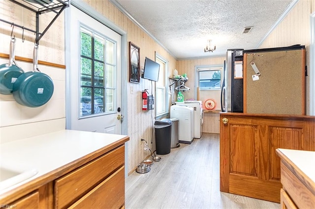 795 Old Oyster Point Rd, Newport News, VA 23602 - laundry area featuring ornamental molding, light wood finished floors, a textured ceiling, and washer / dryer