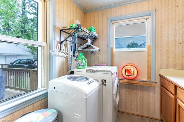 795 Old Oyster Point Rd, Newport News, VA 23602 - washroom with wallpapered walls, washer and clothes dryer, healthy amount of natural light, and wood finished floors