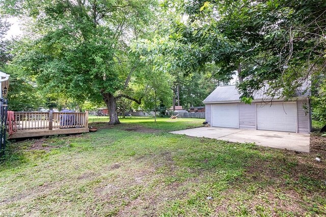 795 Old Oyster Point Rd, Newport News, VA 23602 - view of green lawn with an outdoor structure, a detached garage, and a deck