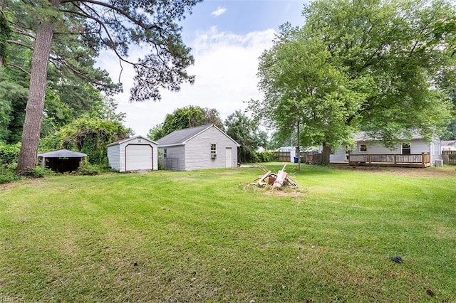 795 Old Oyster Point Rd, Newport News, VA 23602 - view of grassy yard with a detached garage, an outbuilding, and a wooden deck