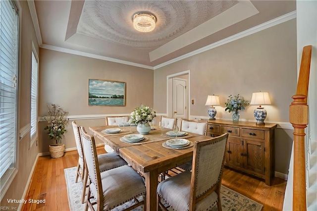 204 Goshawk Ct, Suffolk, VA 23435 - dining room featuring a raised ceiling, light wood-type flooring, and baseboards