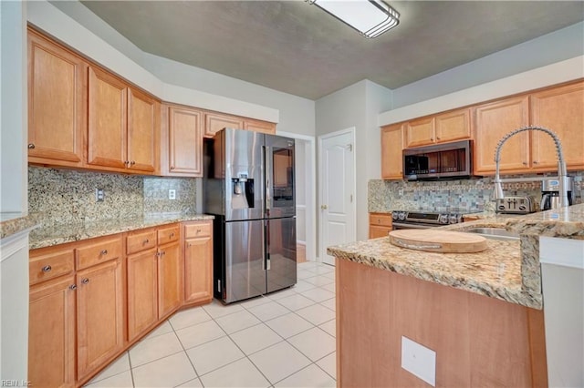 204 Goshawk Ct, Suffolk, VA 23435 - kitchen with appliances with stainless steel finishes, decorative backsplash, light stone counters, and light tile patterned floors