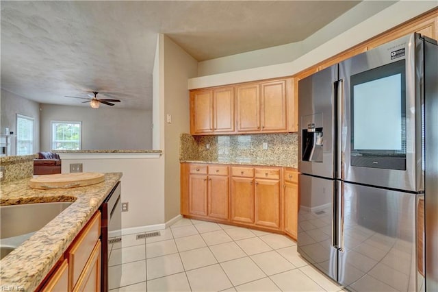 204 Goshawk Ct, Suffolk, VA 23435 - kitchen with stainless steel appliances, baseboards, ceiling fan, decorative backsplash, and light stone counters