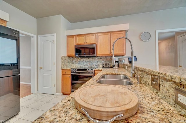 204 Goshawk Ct, Suffolk, VA 23435 - kitchen featuring stainless steel appliances, a sink, light tile patterned floors, backsplash, and light stone counters