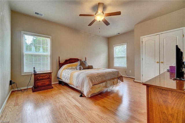204 Goshawk Ct, Suffolk, VA 23435 - bedroom with light wood-style floors, multiple windows, baseboards, and ceiling fan