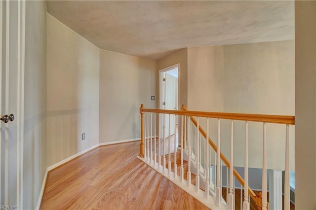 204 Goshawk Ct, Suffolk, VA 23435 - hallway with wood finished floors, an upstairs landing, and baseboards