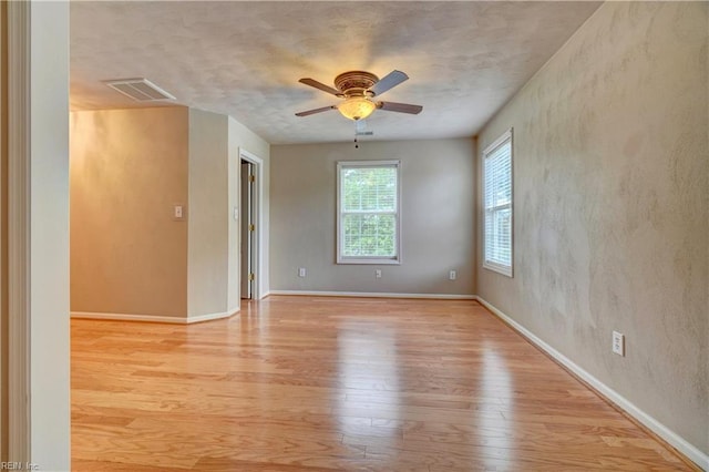 204 Goshawk Ct, Suffolk, VA 23435 - empty room with light wood finished floors, ceiling fan, and baseboards