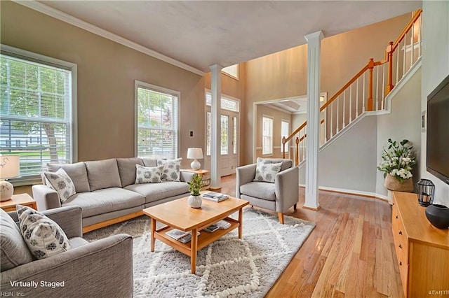 204 Goshawk Ct, Suffolk, VA 23435 - living room with light wood-type flooring, stairway, ornamental molding, baseboards, and ornate columns