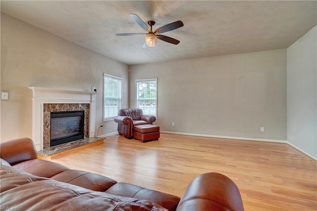 204 Goshawk Ct, Suffolk, VA 23435 - living room with wood finished floors, ceiling fan, baseboards, and a high end fireplace
