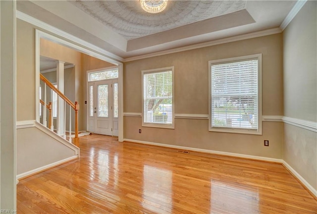 204 Goshawk Ct, Suffolk, VA 23435 - foyer featuring wood finished floors, a tray ceiling, baseboards, stairway, and crown molding