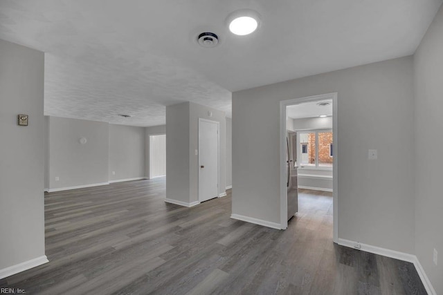 376 Merrimac Trl Unit 113, Williamsburg, VA 23185 - spare room with baseboards and dark wood-style flooring