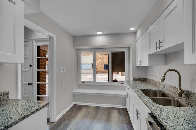376 Merrimac Trl Unit 113, Williamsburg, VA 23185 - kitchen with a sink, white cabinets, dark wood-style flooring, light stone countertops, and recessed lighting