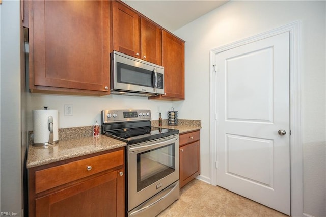 471 Abelia Way, Chesapeake, VA 23322 - kitchen with stainless steel appliances, light stone counters, and brown cabinetry
