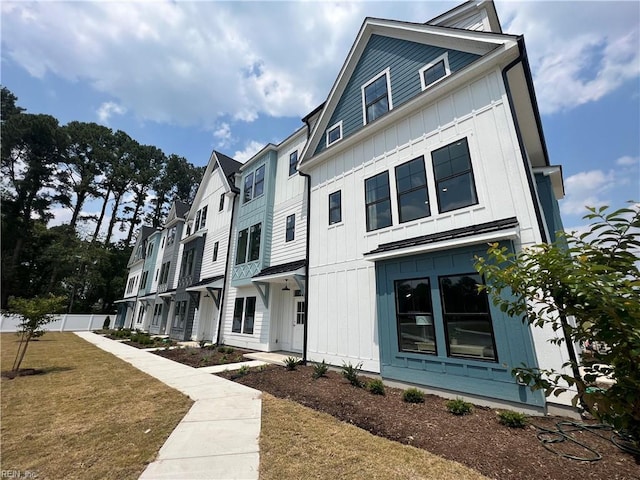 909 Jennings Ln, Chesapeake, VA 23322 - view of front of house with board and batten siding and a front yard