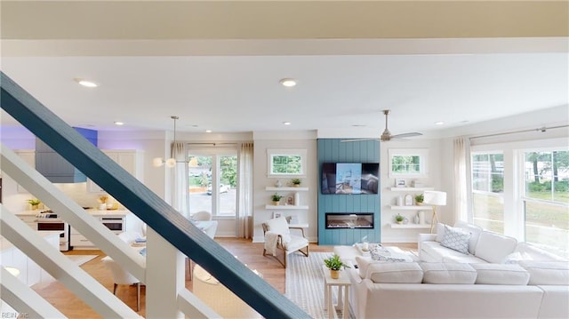 909 Jennings Ln, Chesapeake, VA 23322 - living room featuring plenty of natural light, a fireplace, a ceiling fan, recessed lighting, and light wood-style floors