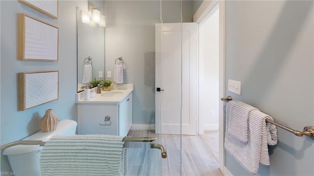 909 Jennings Ln, Chesapeake, VA 23322 - bathroom with vanity, wood finished floors, and baseboards