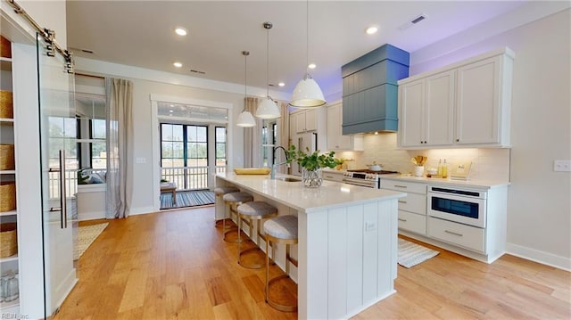 909 Jennings Ln, Chesapeake, VA 23322 - kitchen featuring white oven, stainless steel range with gas cooktop, light countertops, backsplash, and white cabinets
