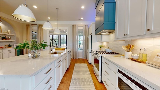909 Jennings Ln, Chesapeake, VA 23322 - kitchen with white appliances, a sink, custom exhaust hood, tasteful backsplash, and light stone countertops