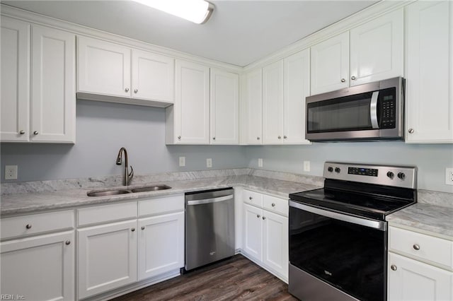 2816 N Nansemond Dr, Suffolk, VA 23435 - kitchen with appliances with stainless steel finishes, a sink, white cabinetry, and dark wood-style flooring