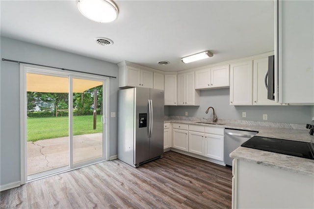 2816 N Nansemond Dr, Suffolk, VA 23435 - kitchen featuring appliances with stainless steel finishes, a sink, dark wood-style floors, white cabinetry, and baseboards