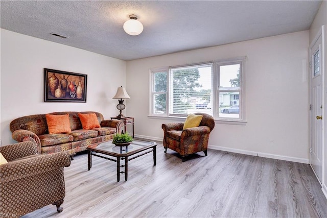 115 Bowen Dr, Hampton, VA 23666 - living room with light wood finished floors and a textured ceiling