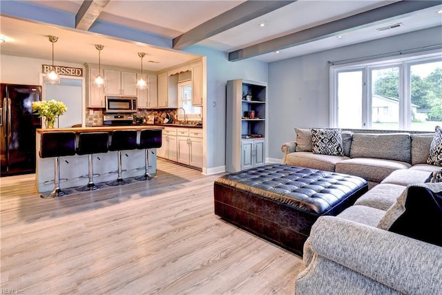 115 Bowen Dr, Hampton, VA 23666 - living room featuring light wood-style flooring, beam ceiling, healthy amount of natural light, and recessed lighting
