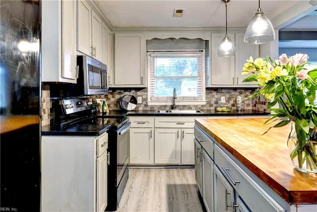 115 Bowen Dr, Hampton, VA 23666 - kitchen featuring black appliances, wooden counters, decorative backsplash, and light wood-style floors
