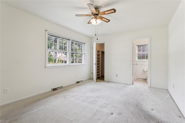 122 Avery Cres, Newport News, VA 23606 - unfurnished bedroom with multiple windows, a walk in closet, carpet, and ensuite bathroom
