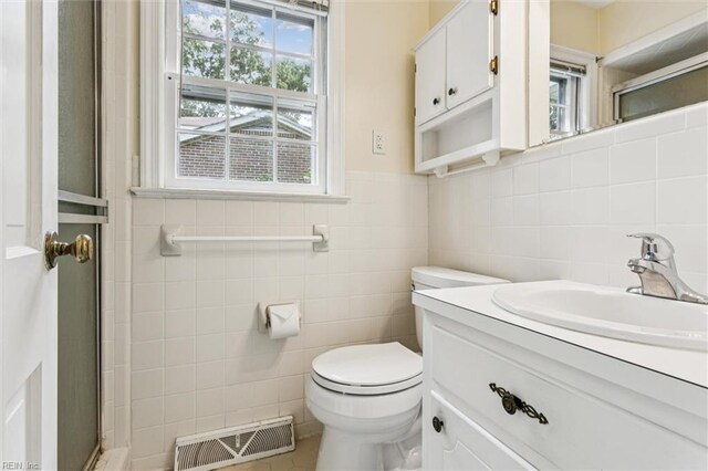 122 Avery Cres, Newport News, VA 23606 - bathroom with tile walls, vanity, toilet, a shower with door, and tile patterned flooring