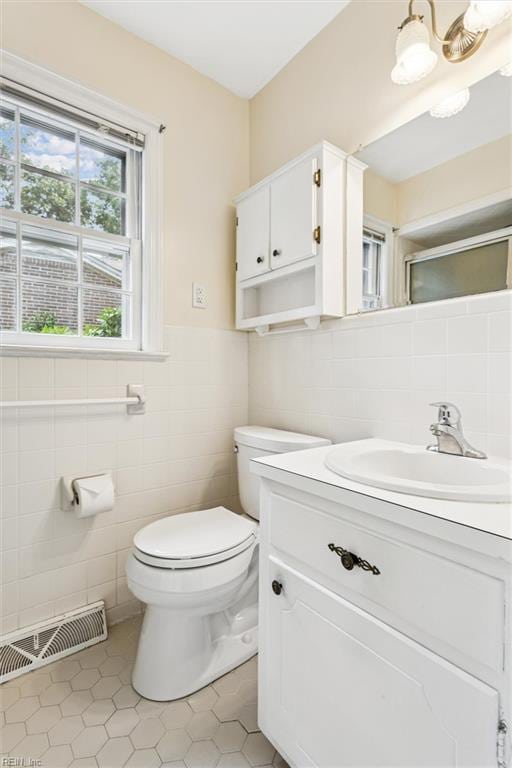 122 Avery Cres, Newport News, VA 23606 - bathroom with tile walls, toilet, vanity, tile patterned floors, and wainscoting