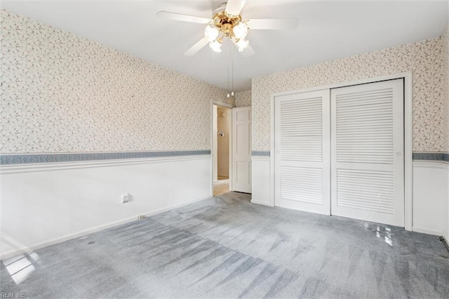 122 Avery Cres, Newport News, VA 23606 - unfurnished bedroom featuring wallpapered walls, a wainscoted wall, a closet, carpet flooring, and a ceiling fan