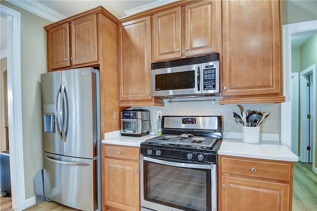 1228 Cherrytree Ln, Chesapeake, VA 23320 - kitchen featuring appliances with stainless steel finishes, light countertops, light wood-style floors, ornamental molding, and brown cabinets