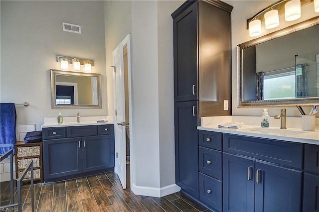 1228 Cherrytree Ln, Chesapeake, VA 23320 - bathroom featuring wood finish floors, two vanities, and baseboards