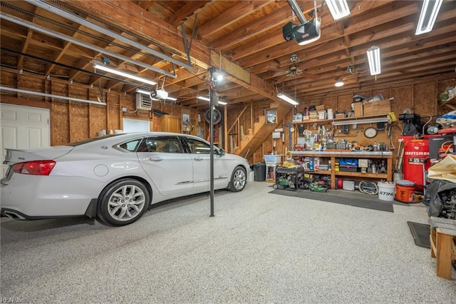 905 Lela Ln, Chesapeake, VA 23322 - garage with a garage door opener and a workshop area