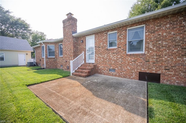 905 Lela Ln, Chesapeake, VA 23322 - view of front facade featuring a patio, a front lawn, a chimney, brick siding, and entry steps