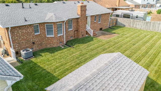 905 Lela Ln, Chesapeake, VA 23322 - back of house with a chimney, a fenced backyard, brick siding, and a shingled roof