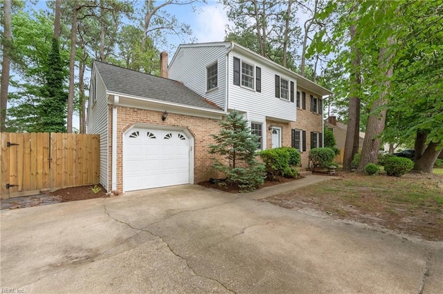 10 Kathy Dr, Poquoson, VA 23662 - view of front of home with brick siding, an attached garage, concrete driveway, and a chimney