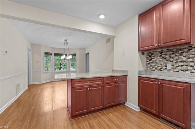 10 Kathy Dr, Poquoson, VA 23662 - kitchen with light wood-style flooring, a peninsula, backsplash, light stone countertops, and baseboards