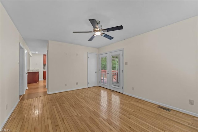10 Kathy Dr, Poquoson, VA 23662 - spare room featuring light wood finished floors, baseboards, a ceiling fan, and french doors