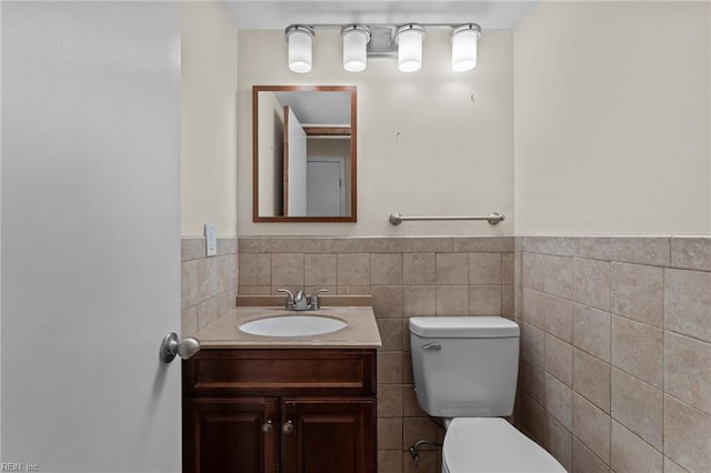 10 Kathy Dr, Poquoson, VA 23662 - bathroom with tile walls, toilet, vanity, and a wainscoted wall